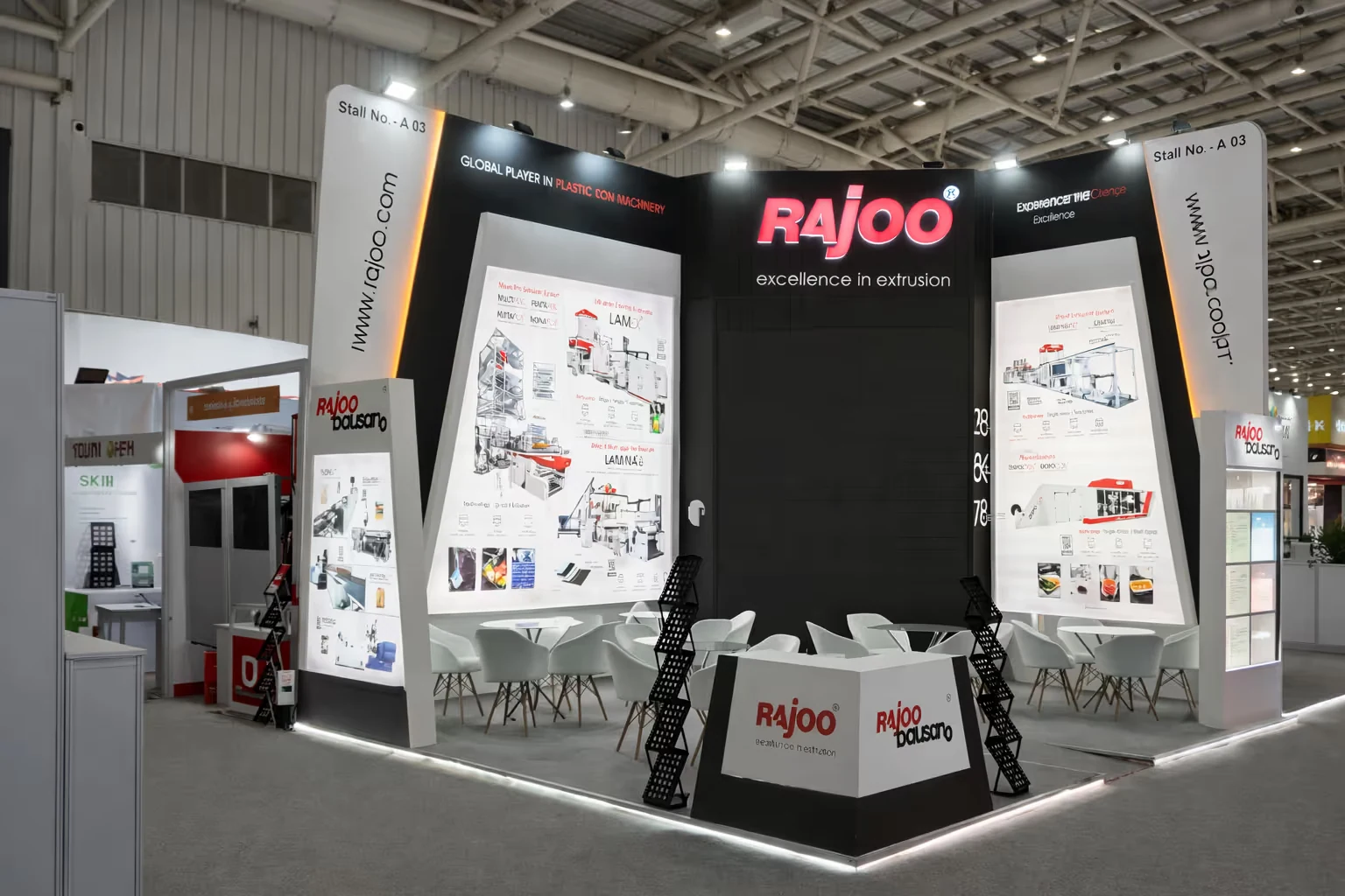 Rajoo exhibition stall with illuminated product displays and seating area at a trade show.