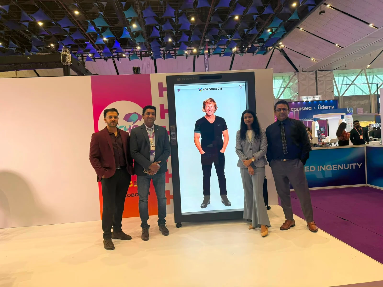 Visitors beside the HoloBox911 display showing an AI avatar of Jonty Rhodes at People Matters TechHR India 2026